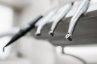 A detailed view of stainless steel dental tools in a modern dentist's office.